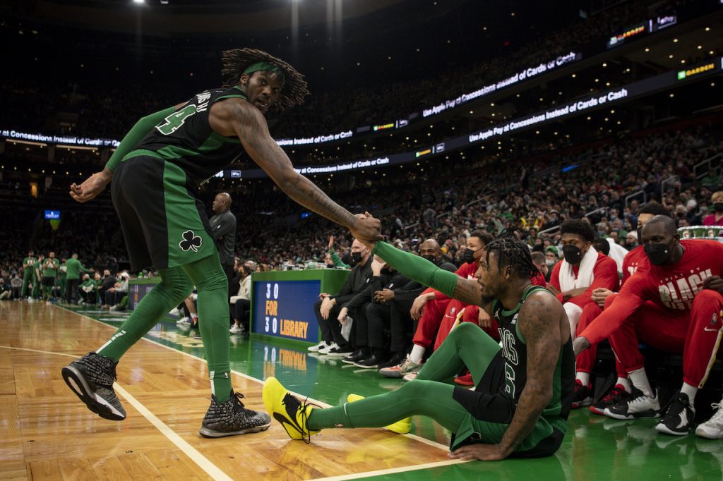 Robert Williams helps up Marcus Smart.