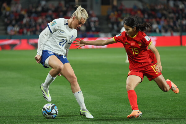 Russo, at left, dribbles the ball against a player from China, at right.