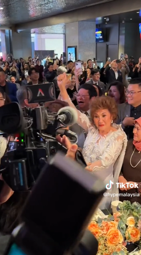 Michelle Yeoh's mum, Janet Yeoh, celebrates her daughter's Oscar win from a telecast in Malaysia.