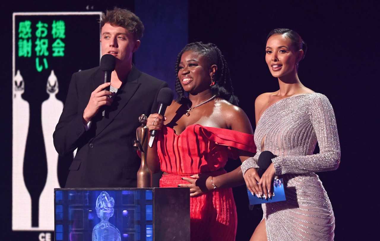 Roman Kemp, Clara Amfo and Maya Jama on stage to present the award for International Group during The BRIT Awards 2023 at The O2 Arena on February 11, 2023