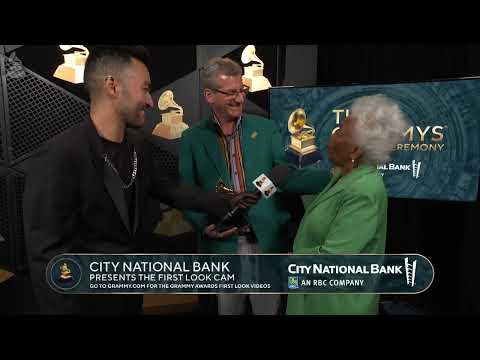 ROBERT GORDON AND DEANIE PARKER Checks In At The CNB First Look Cam At The 2024 GRAMMYs