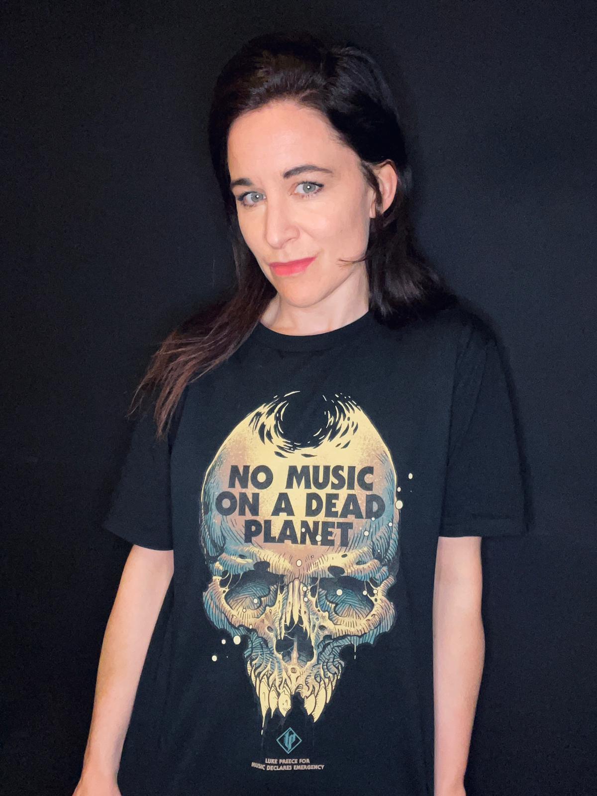 Music Declares Emergency founder Fay Milton of Savages in a new No Music On A Dead Planet t-shirt
