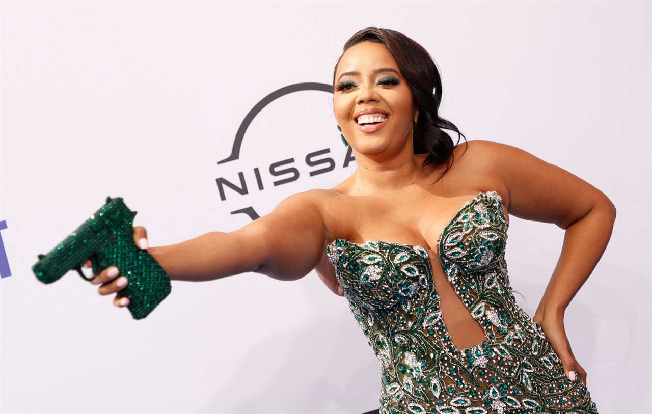 Angela Simmons posing with gun-shaped clutch bag at the 2024 BET Awards. Photo credit: MICHAEL TRAN/AFP via Getty Images