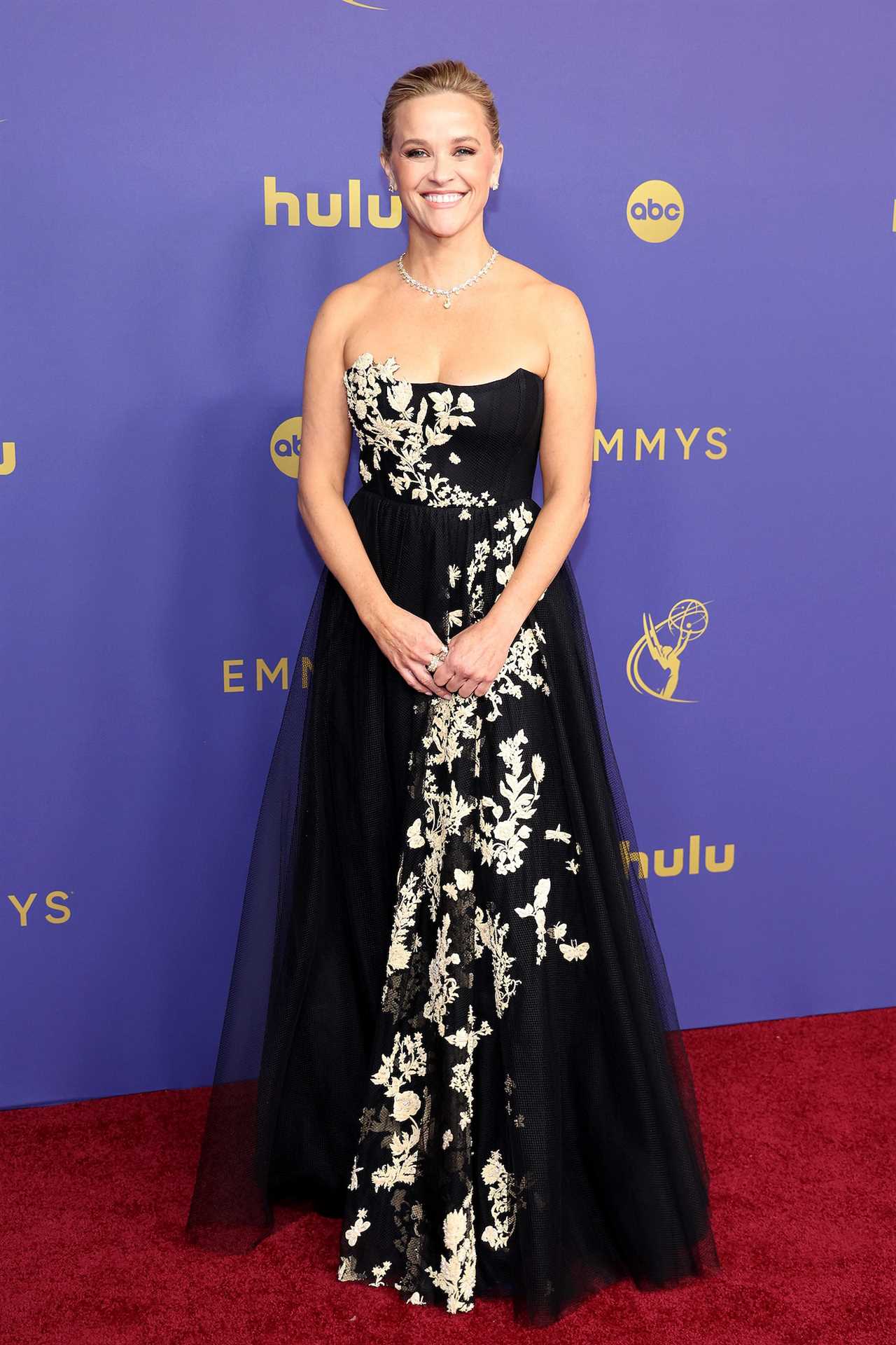 Reese Witherspoon Looks Regal in Black and Gold at 2024 Emmy Awards Red Carpet