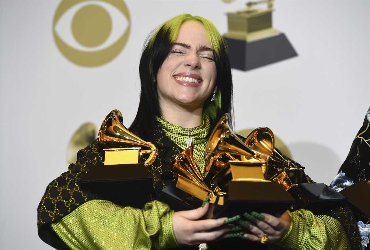 Billie Eilish poses in the press room with the awards for best album and best pop vocal album for "We All Fall Asleep, Where Do We Go?", best song and record for "Bad Guy" and best new artist at the 62nd annual Grammy Awards at the Staples Center on Sunday, Jan. 26, 2020, in Los Angeles. 