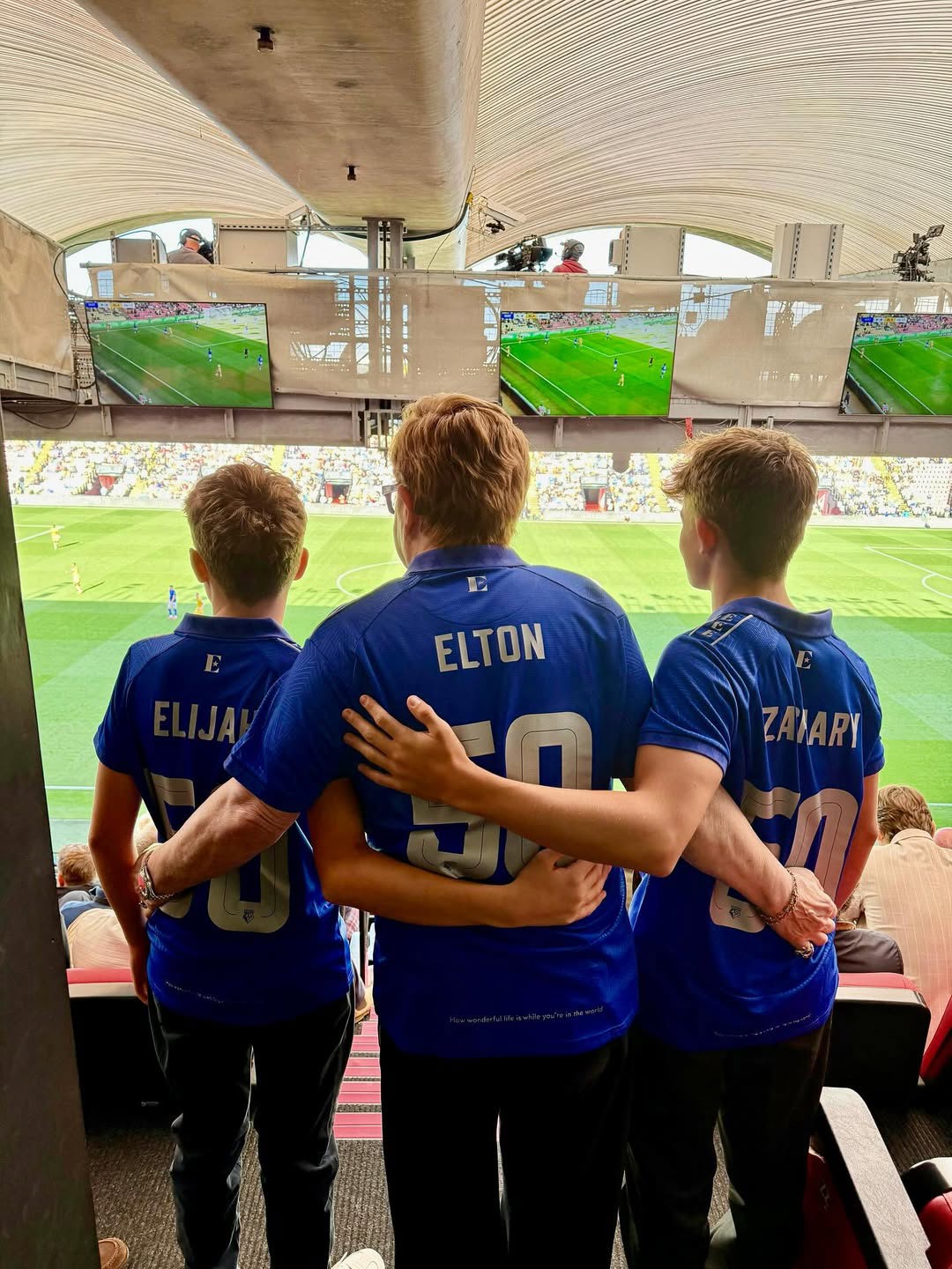 Elton John with his sons at a Watford FC game.