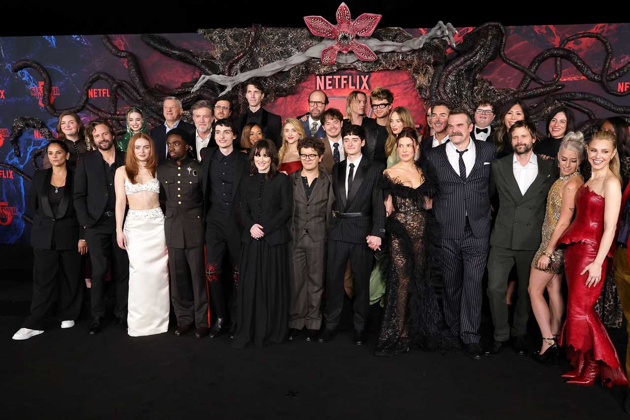 HOLLYWOOD, CALIFORNIA - NOVEMBER 06: (L-R) Bela Bajaria, CCO, Netflix, Emily Morris, Matt Duffer, Nell Fisher, Sadie Sink, Ted Sarandos, Co-CEO, Netflix, Caleb McLaughlin, Joe Chrest, Finn Wolfhard, Dan Cohen, Winona Ryder, Alex Breaux, Priah Ferguson, Gaten Matarazzo, Natalia Dyer, Brett Gelman, Noah Schnapp, Jamie Campbell Bower, Charlie Heaton, Joe Keery, Maya Hawke, Millie Bobby Brown, Amybeth McNulty, Shawn Levy, David Harbour, Jake Connelly, Jinny Howe, VP of Drama Development, Netflix, Ro