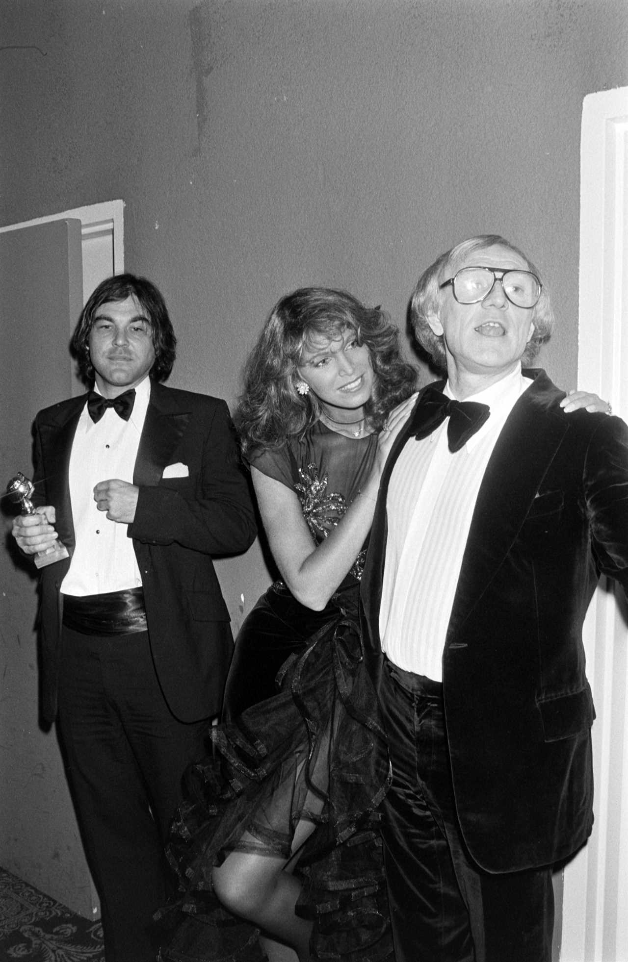 (L-R) Oliver Stone, Ann Turkel, and Richard Harris attend an awards ceremony at the Beverly Hills Hotel in Beverly Hills, California, on December 27, 1979.