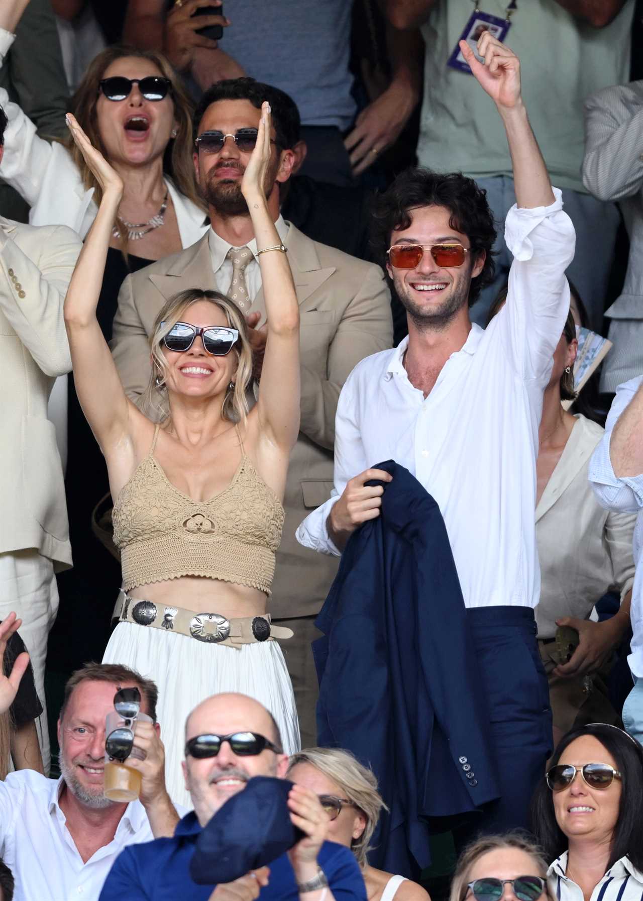 Sienna Miller and Oli Green on day 14 of the Wimbledon Tennis Championships at the All England Trennis and Croquet Club at on July 13, 2025 in London, England.