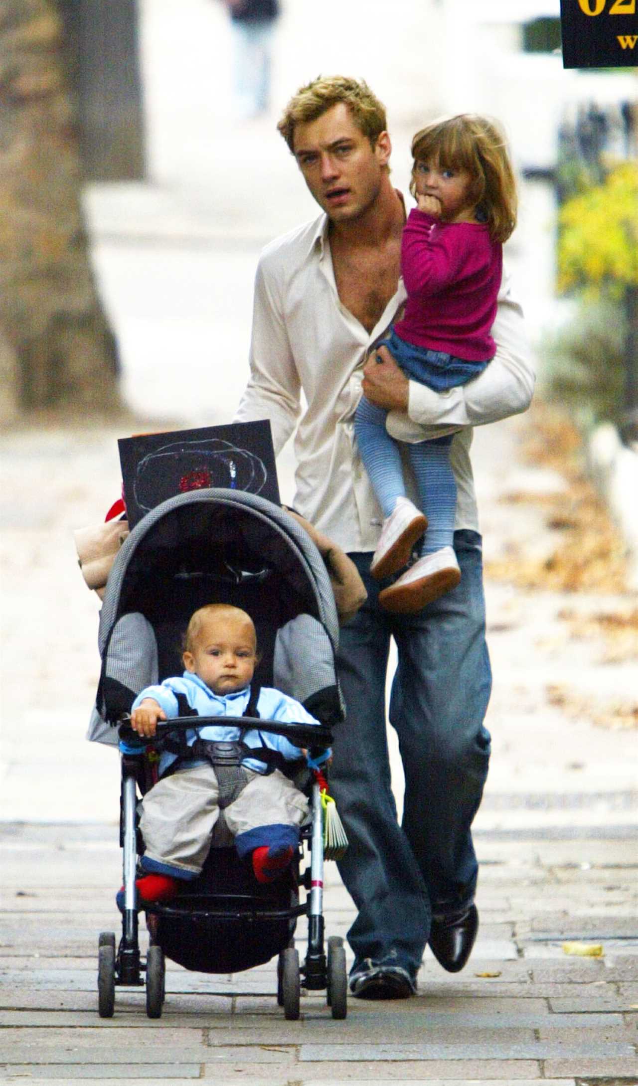 Jude Law walks with Rudy in pram and Iris in North London in October 2003.