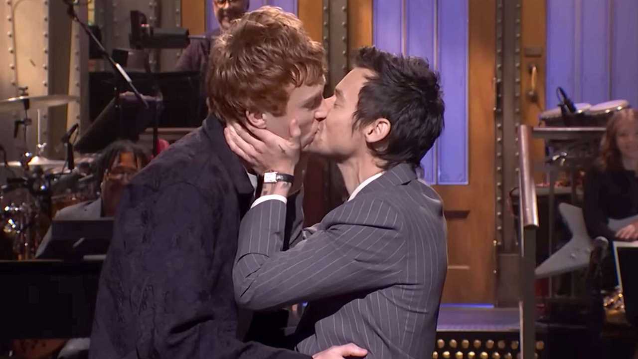 Harry Styles plants a kiss on comedian Ben Marshall during SNL monologue